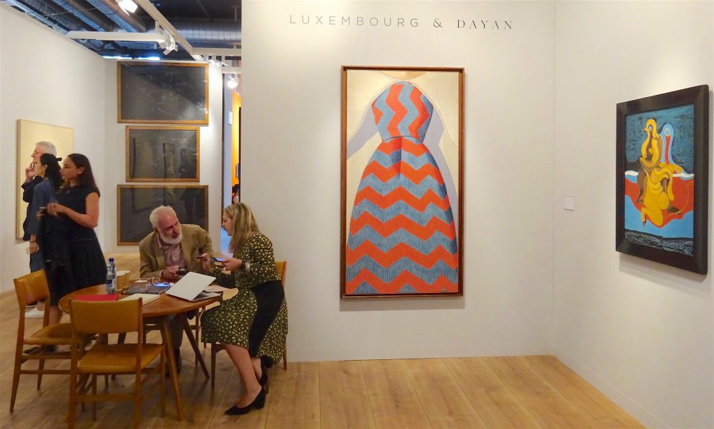 Curator Mr. Francesco Bonami sitting at the table, Luxembourg & Dayan booth