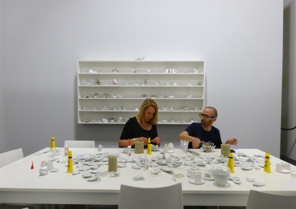 Yoko Ono “Mend Piece (Galerie Lelong version) 1966-2018, Table, chairs, shelving, ceramic, glue, tape, scissors, and twine; dimensions variable, UNLIMITED Galerie Lelong & Co.