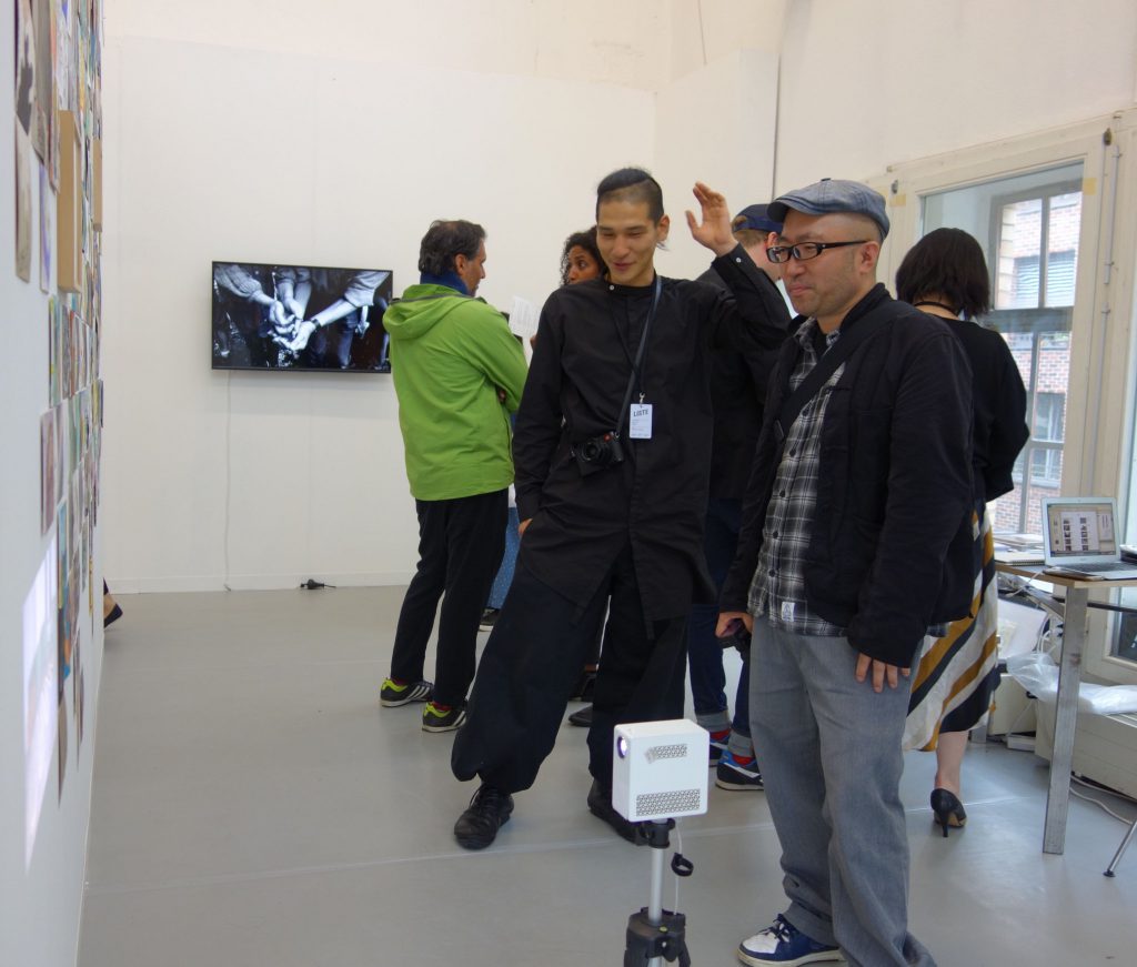 LISTE 2019, booth of MUJIN-TO Production 無人島プロダクション, artist TAGUCHI Yukihiro 田口 行弘 with collector YOSHINO Seiichi 吉野誠一