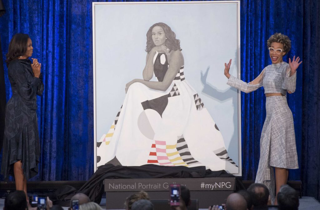 Former First Lady Michelle Obama and Amy Sherald stand next to Mrs. Obama’s portrait at the Smithsonian National Portrait Gallery