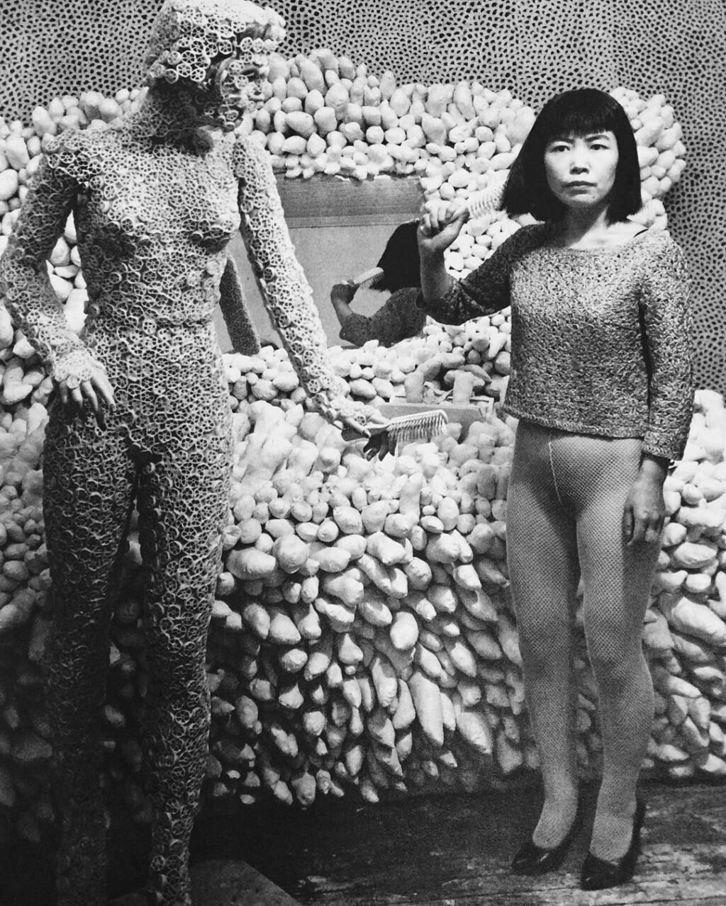 Kusama posing with her works, around 1964