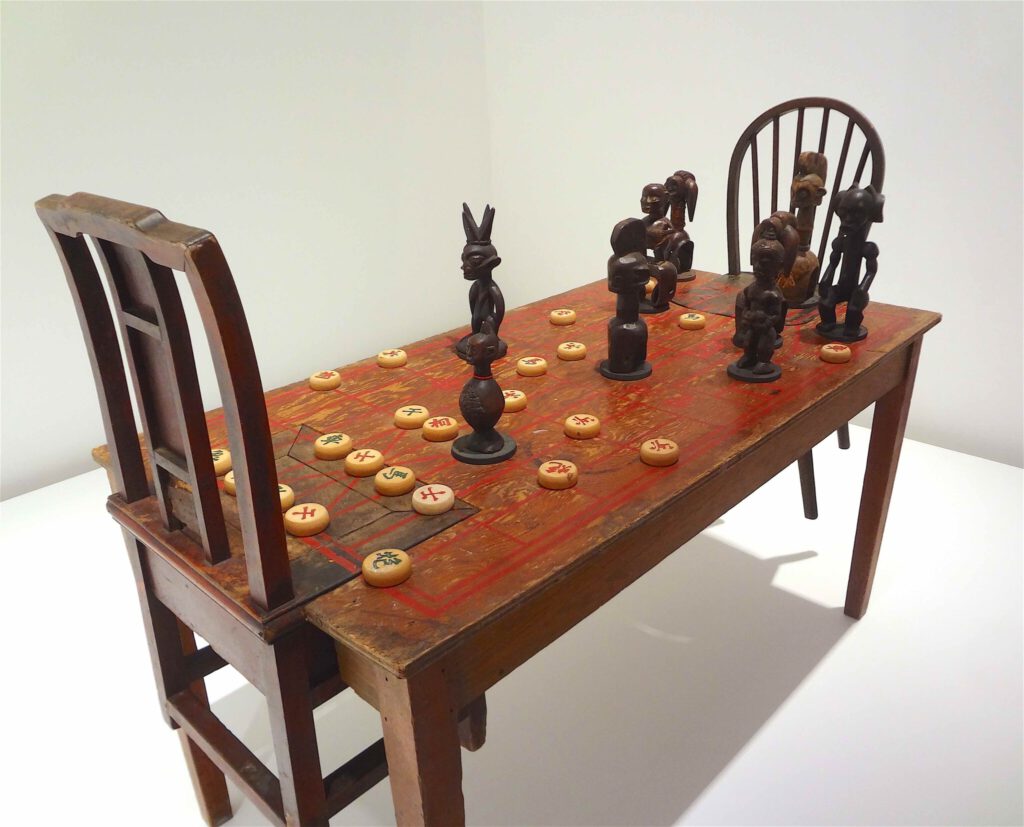 Chen Zhen “Couldn’t Bananas Be Black” 1999, Wood, chairs, African statuettes, Chinese chess, detail1