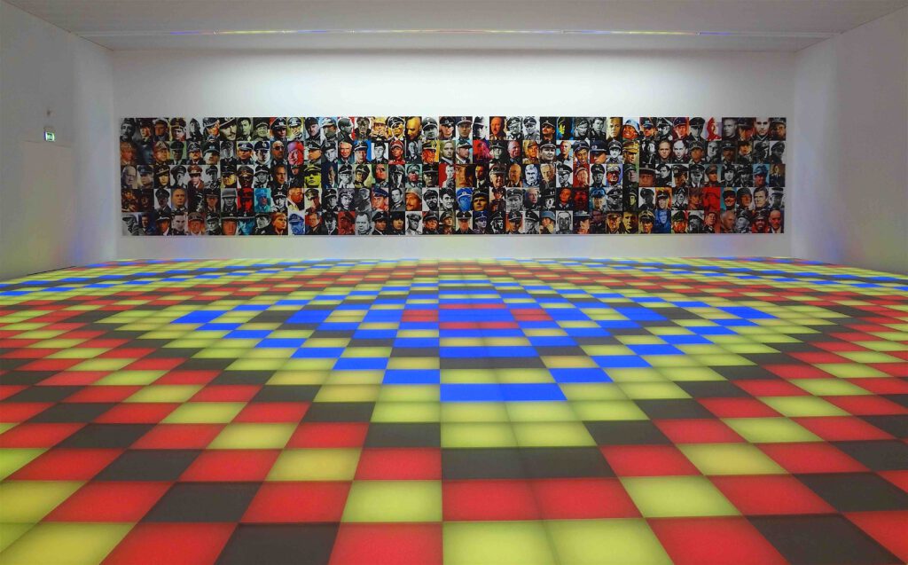 Piotr Uklanski “Untitled (Dancing Nazis)” 2008, Plexiglas panels, coloured lightbulbs, raised floor structure, audio equipment and computer-controlled sound system