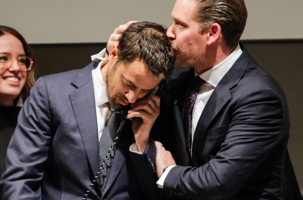 Christie’s Chairman Alex Rotter kisses during auction