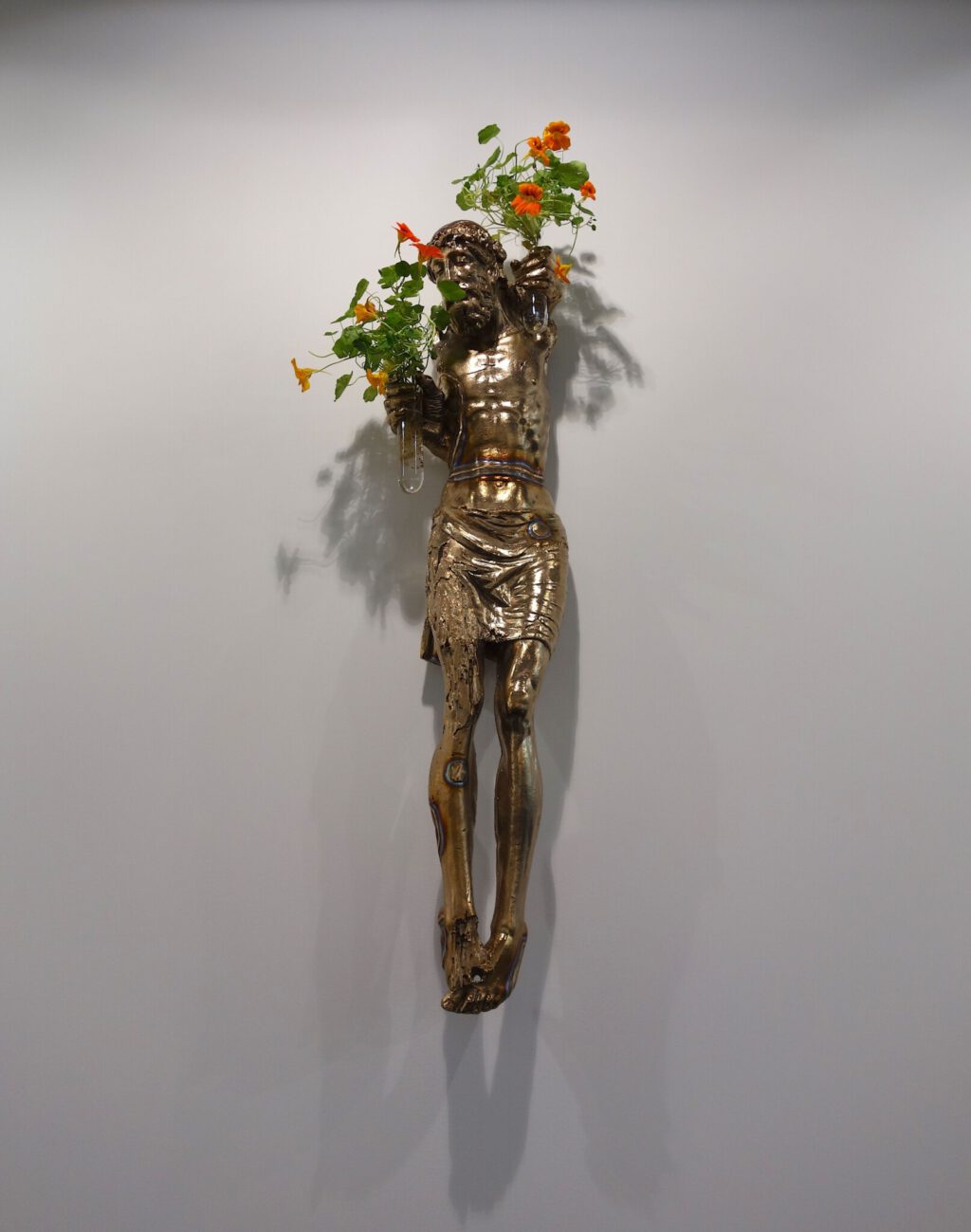 Danh Vo Untitled 2023 Bronze 16th century Spanish figure of Christ and Phung Vo’s hands and Tropaeolum Majus. 121 x 30 x 22 cm @ WHITE CUBE Art Basel 2024