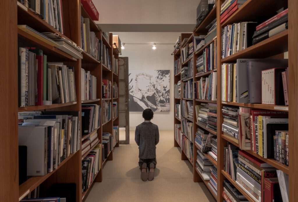 Maurizio Cattelan’s Him (2001) in the library stacks of Edlis and Neeson’s residence. | Maurizio Cattelan "Him" (2001) in the library stacks of Edlis and Neeson’s residence. Maurizio Cattelan’s Him (2001) in the library stacks of Edlis and Neeson’s residence. | Maurizio Cattelan "Him" (2001) in the library stacks of Edlis and Neeson’s residence.