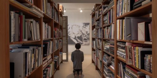 Maurizio Cattelan’s Him (2001) in the library stacks of Edlis and Neeson’s residence. | Maurizio Cattelan  "Him" (2001) in the library stacks of Edlis and Neeson’s residence.