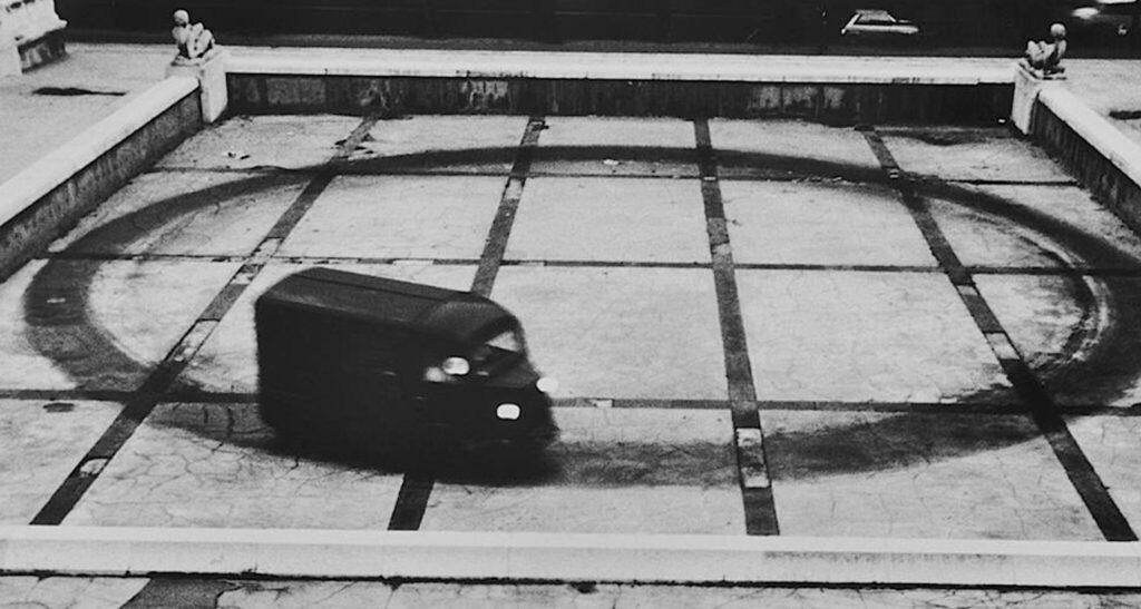 Relation in Movement video 1977. Ulay and Abramovic drive a Citroen type H van round and round in a circle inside a city square in Paris